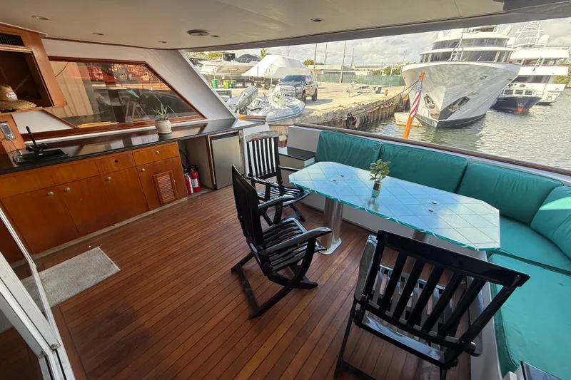 Slide: The Image of Luxurious 1990 Denison Pilothouse Cockpit Motoryacht with elegant outdoor seating and wooden deck. - 36