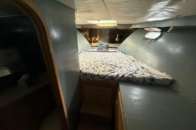 Slide: The Image of Cozy cabin interior of 1990 Denison Pilothouse Cockpit Motoryacht with nautical-themed bedding. - 48