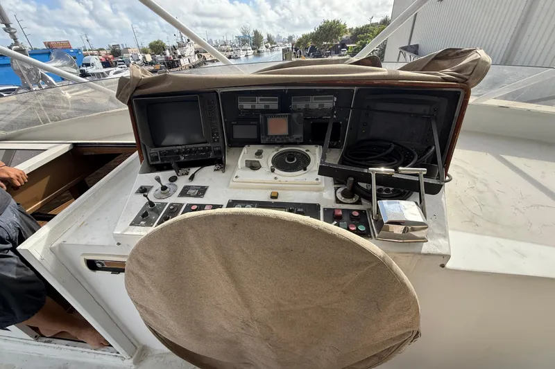 Slide: The Image of 1990 Denison Pilothouse Cockpit Motoryacht helm with navigation equipment and controls. - 50