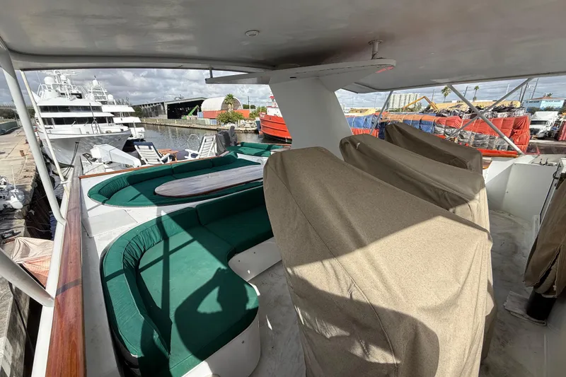 Slide: The Image of 1990 Denison Pilothouse Cockpit Motoryacht with covered seating and marina view. - 52
