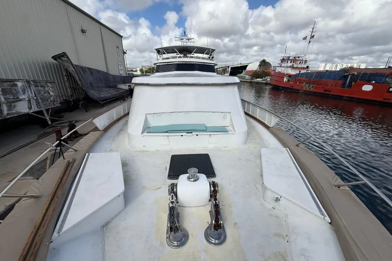 Slide: The Image of 1990 Denison Pilothouse Cockpit Motoryacht docked, showcasing spacious deck and waterfront view. - 56
