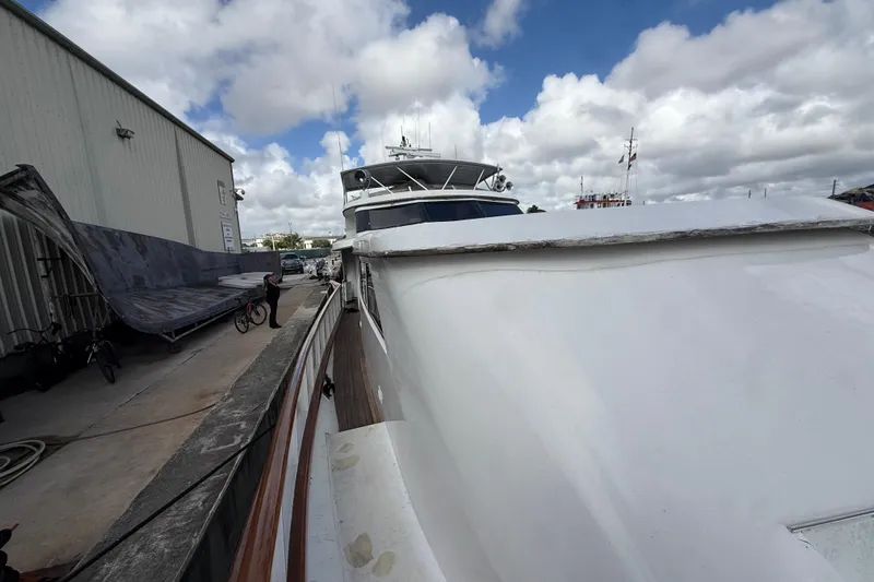 Slide: The Image of 1990 Denison Pilothouse Cockpit Motoryacht docked beside a warehouse under cloudy skies. - 57