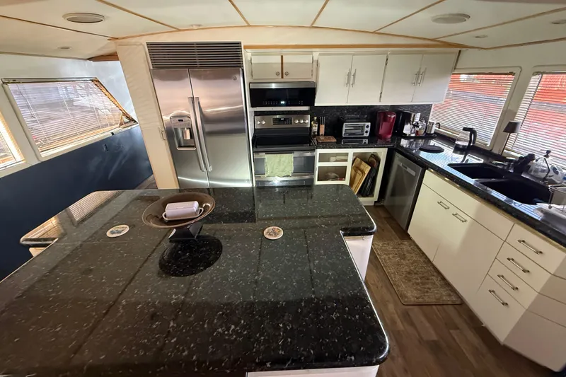 Slide: The Image of Luxurious kitchen in 1990 Denison Pilothouse Cockpit Motoryacht with modern appliances and granite countertops. - 62