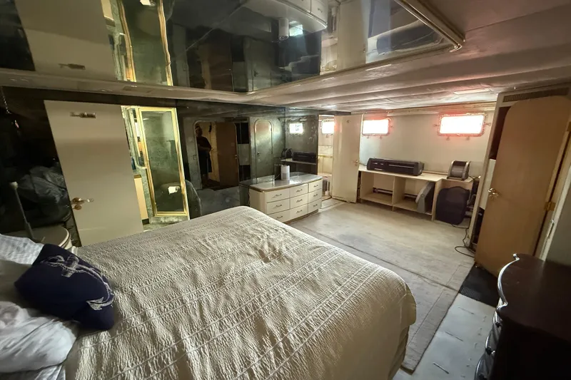 Slide: The Image of Luxurious bedroom interior of 1990 Denison Pilothouse Cockpit Motoryacht with mirrored walls and cozy decor. - 69