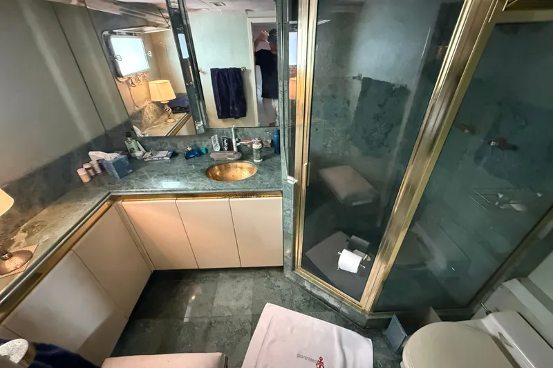 Slide: The Image of Luxurious bathroom in 1990 Denison Pilothouse Cockpit Motoryacht with marble countertops and glass shower. - 72
