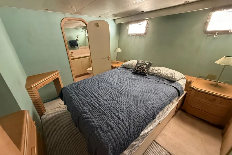 Slide: The Image of Cozy bedroom in 1990 Denison Pilothouse Cockpit Motoryacht with nautical decor and ensuite bathroom. - 74