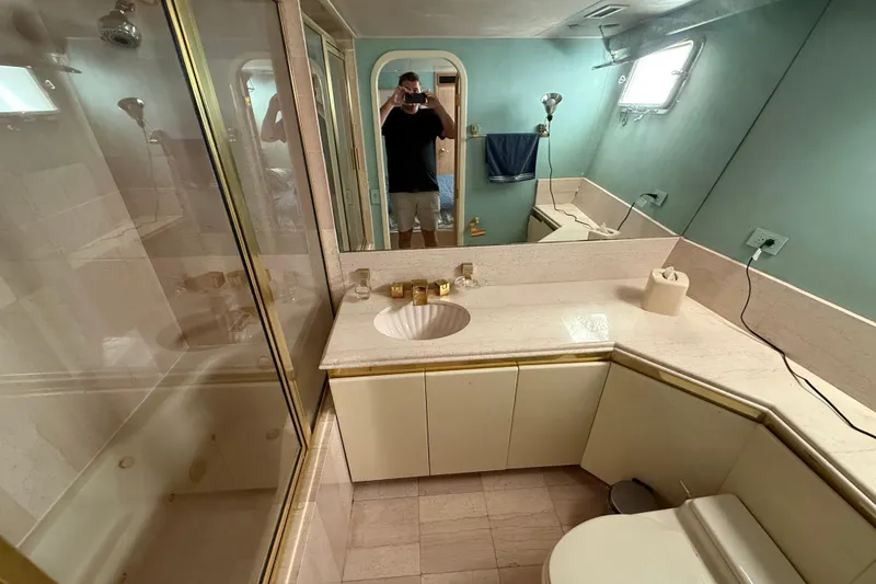 Slide: The Image of Luxurious bathroom in 1990 Denison Pilothouse Cockpit Motoryacht with marble countertop and shower. - 76