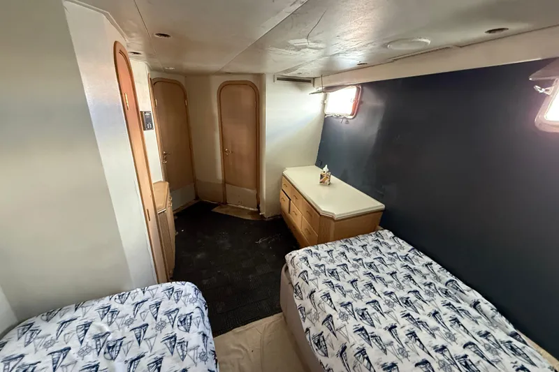 Slide: The Image of 1990 Denison Pilothouse Motoryacht cabin with twin beds and nautical-themed bedding. - 79