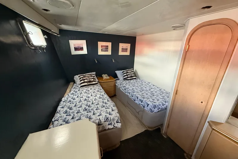 Slide: The Image of Twin beds in a 1990 Denison Pilothouse Cockpit Motoryacht cabin, nautical-themed decor. - 80