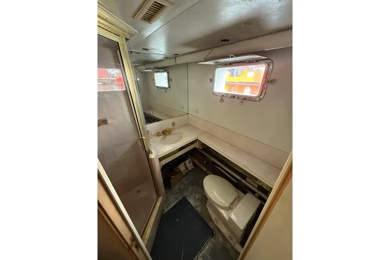 Slide: The Image of Bathroom interior of 1990 Denison Pilothouse Cockpit Motoryacht with sink, toilet, and window. - 81