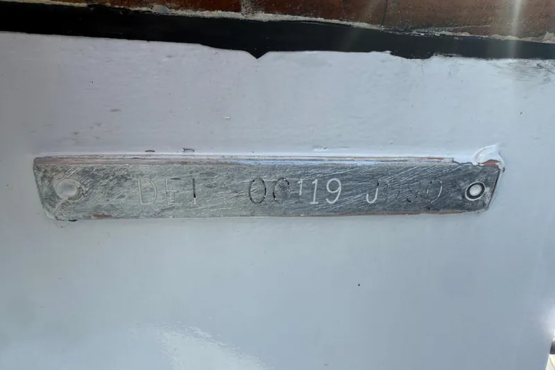 Slide: The Image of 1990 Denison Pilothouse Cockpit Motoryacht hull identification plate on white surface. - 87