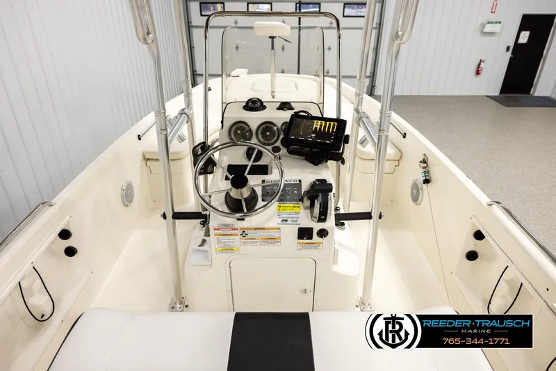 Slide: The Image of 2017 Bayliner Element F21 boat interior with steering wheel and control panel. - 12