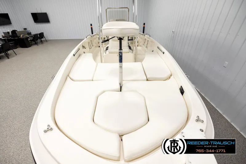 Slide: The Image of 2017 Bayliner Element F21 boat with cushioned seating, displayed indoors at Reeder-Trausch Marine. - 14