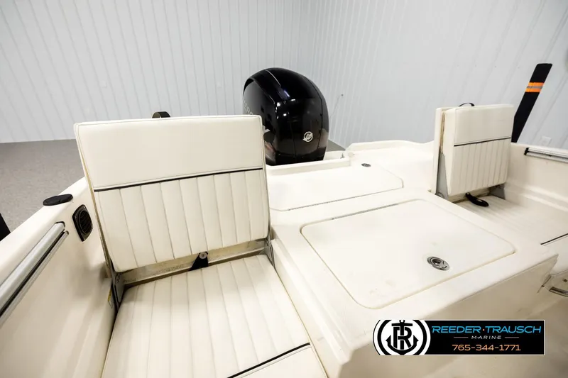Slide: The Image of 2017 Bayliner Element F21 boat interior with white seating and motor, Reeder-Trausch Marine logo. - 17