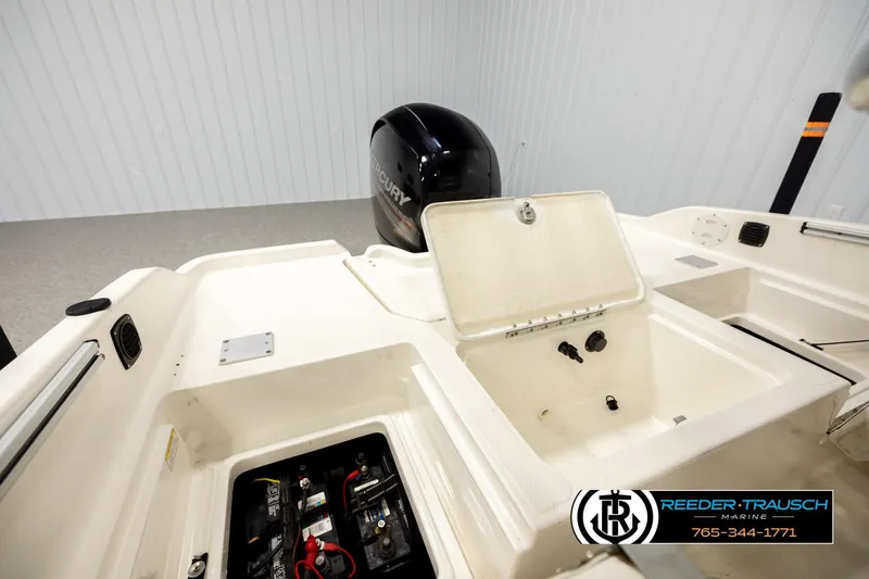 Slide: The Image of 2017 Bayliner Element F21 boat interior with Mercury engine and storage compartments. - 19