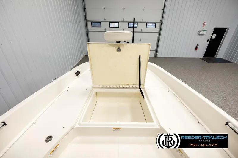 Slide: The Image of 2017 Bayliner Element F21 boat storage compartment in a showroom. - 22