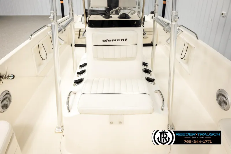 Slide: The Image of 2017 Bayliner Element F21 boat interior with white seating and steering console. - 24