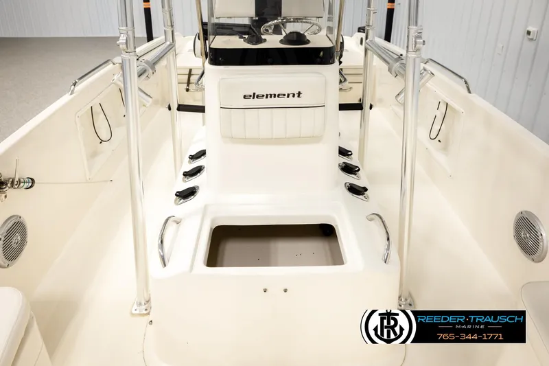 Slide: The Image of 2017 Bayliner Element F21 boat interior with console and storage compartments. - 25