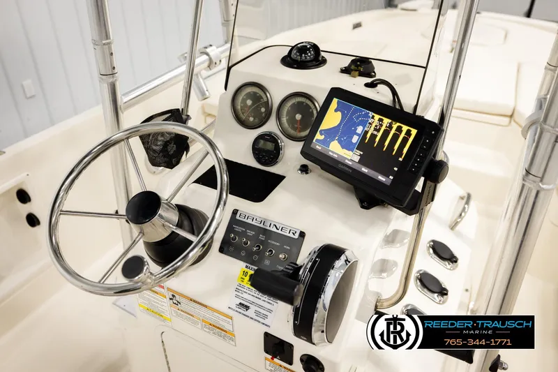 Slide: The Image of 2017 Bayliner Element F21 boat dashboard with steering wheel and navigation system. - 26