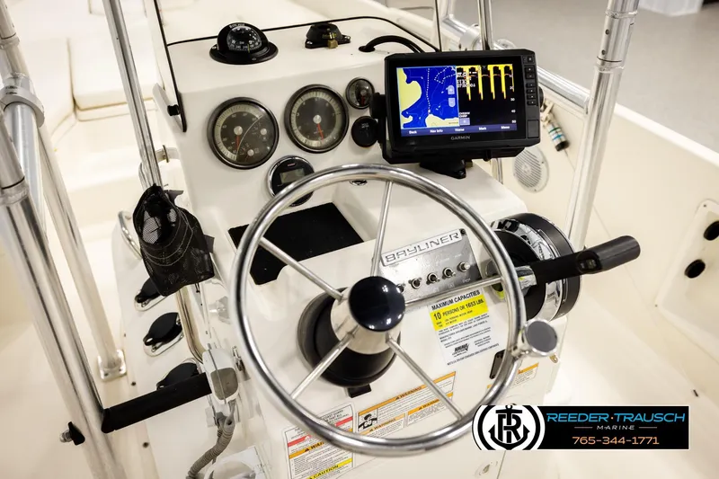 Slide: The Image of 2017 Bayliner Element F21 boat dashboard with steering wheel and Garmin navigation system. - 27