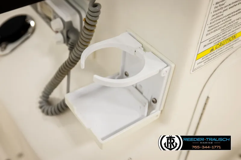 Slide: The Image of 2017 Bayliner Element F21 boat cup holder and caution label detail. - 29