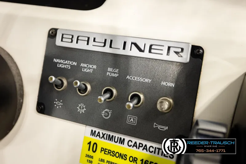 Slide: The Image of Control panel of 2017 Bayliner Element F21 boat with switches and capacity label. - 35