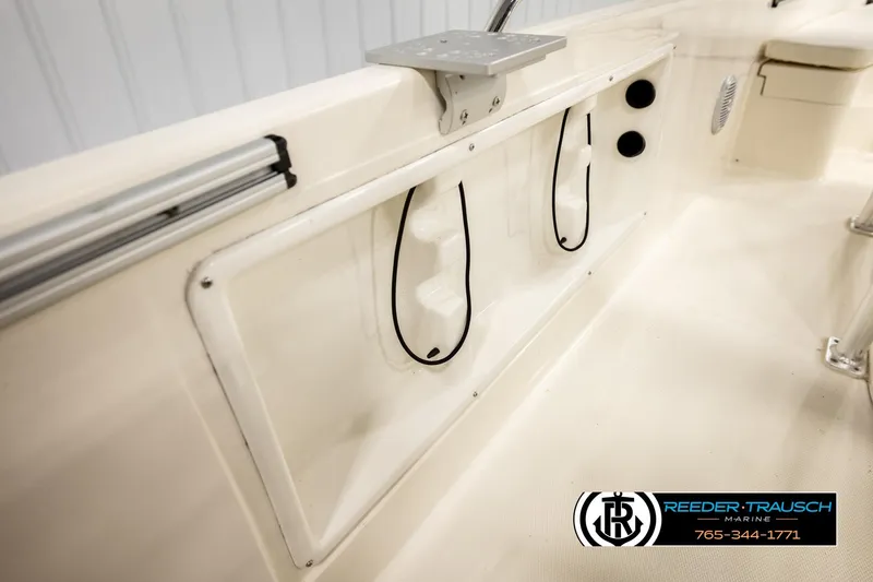Slide: The Image of 2017 Bayliner Element F21 boat interior with storage compartments and seating. - 42