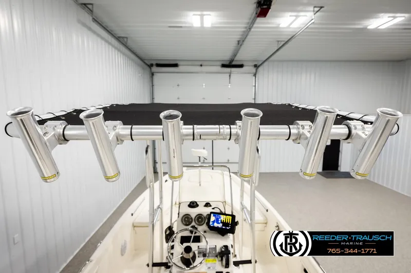 Slide: The Image of 2017 Bayliner Element F21 boat with rod holders in a garage setting. - 46