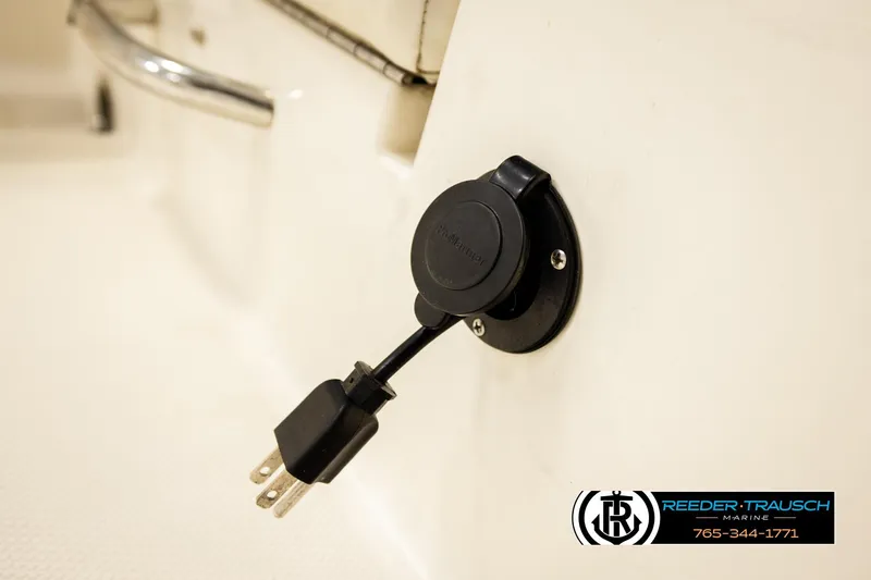 Slide: The Image of 2017 Bayliner Element F21 boat power outlet with plug, Reeder-Trausch Marine branding. - 48