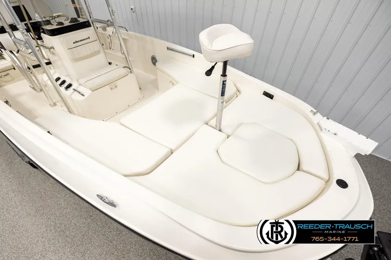 Slide: The Image of 2017 Bayliner Element F21 boat interior with white seating and steering console. - 7
