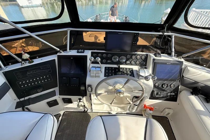 Slide: The Image of 1998 Mainship 47 Motor Yacht helm with navigation instruments and steering wheel. - 14