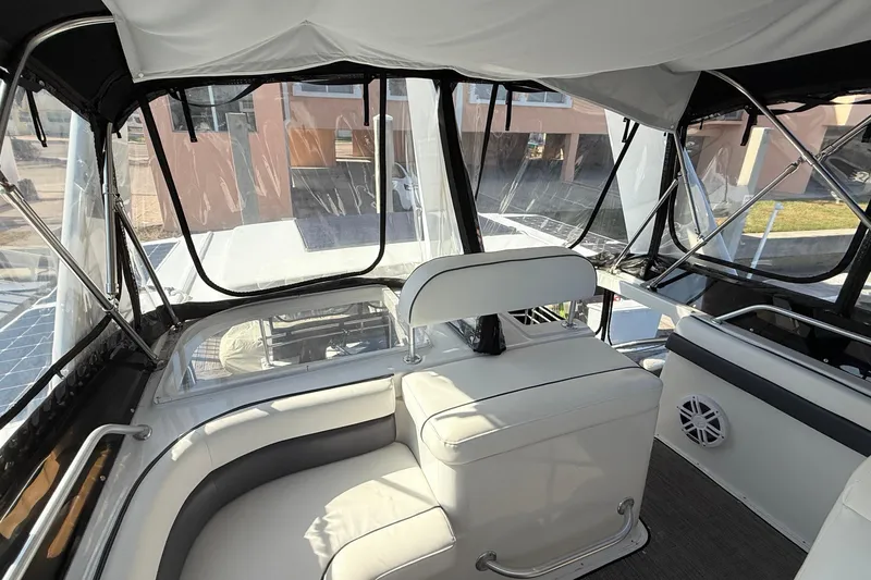 Slide: The Image of 1998 Mainship 47 Motor Yacht interior with white seating and clear windows. - 17