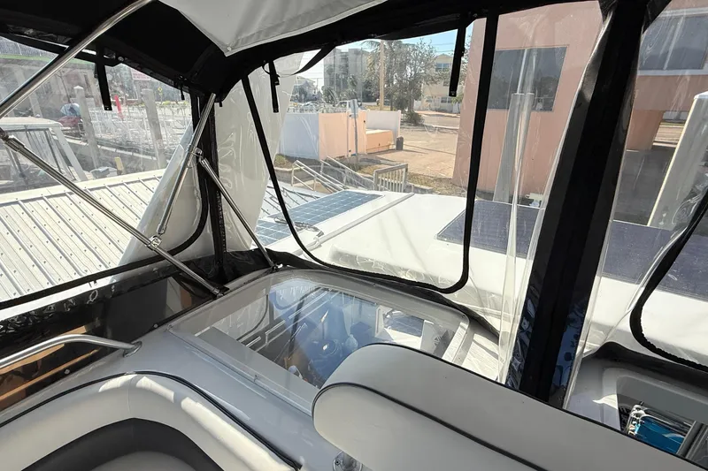 Slide: The Image of Interior view of 1998 Mainship 47 Motor Yacht with clear windows and seating area. - 18