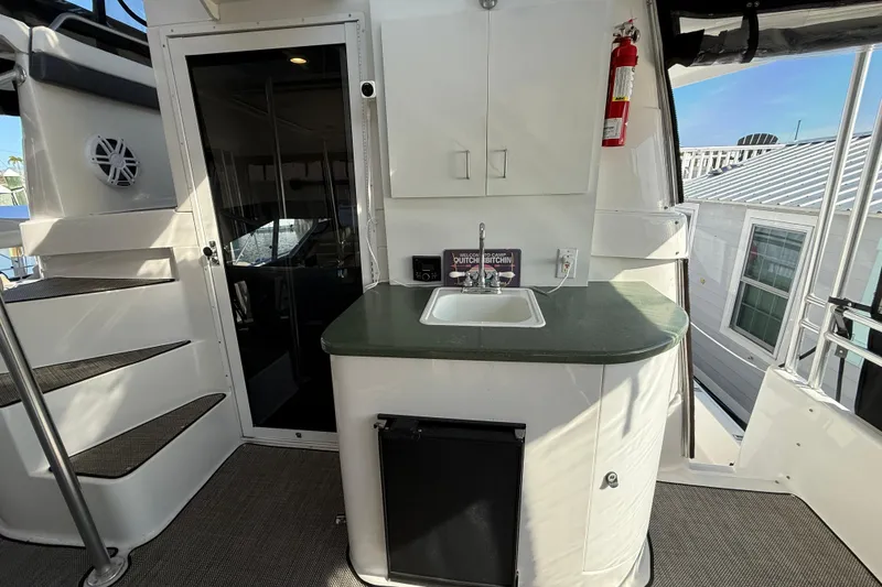 Slide: The Image of 1998 Mainship 47 Motor Yacht interior with sink, countertop, and storage cabinets. - 21