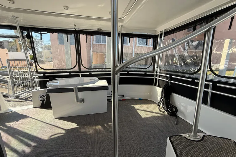 Slide: The Image of 1998 Mainship 47 Motor Yacht interior with spacious seating and panoramic windows. - 23