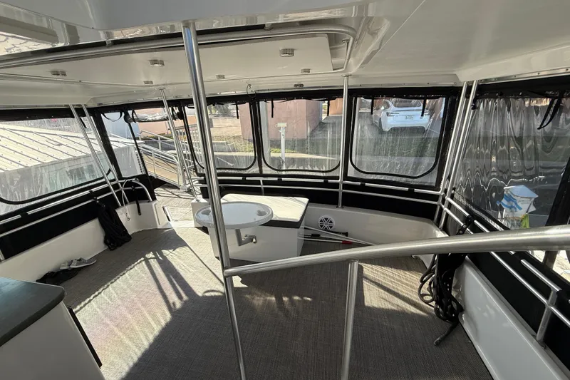 Slide: The Image of Interior view of 1998 Mainship 47 Motor Yacht with spacious seating and windows. - 24