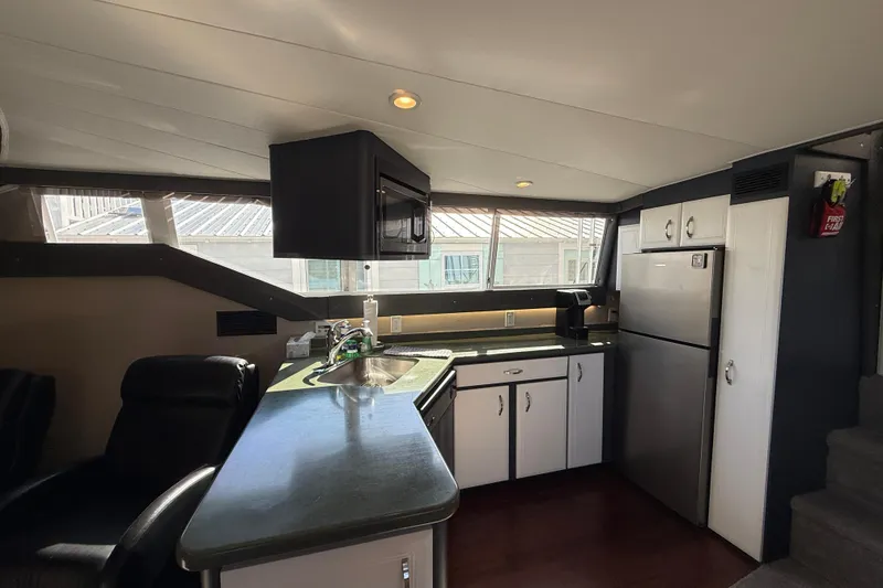 Slide: The Image of Interior of 1998 Mainship 47 Motor Yacht kitchen with modern appliances and sleek design. - 30