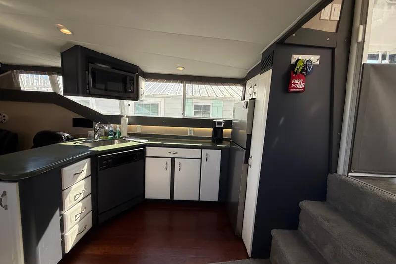 Slide: The Image of Interior of 1998 Mainship 47 Motor Yacht kitchen with modern appliances and wood flooring. - 31