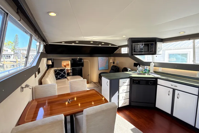 Slide: The Image of Interior of 1998 Mainship 47 Motor Yacht with modern kitchen and seating area. - 33