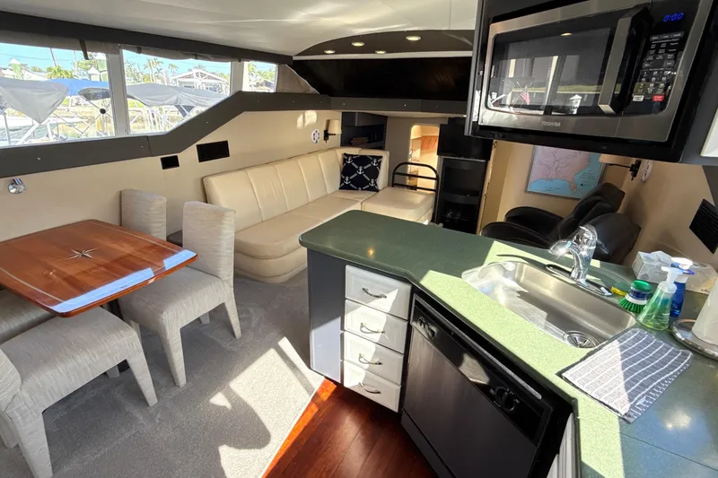 Slide: The Image of Interior of a 1998 Mainship 47 Motor Yacht with modern kitchen and seating area. - 34