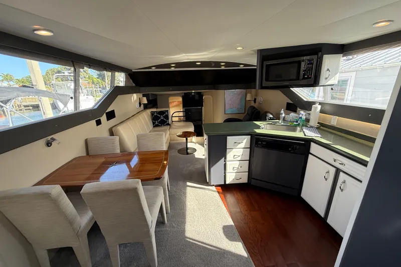 Slide: The Image of Luxurious interior of 1998 Mainship 47 Motor Yacht with dining area and modern kitchen amenities. - 35