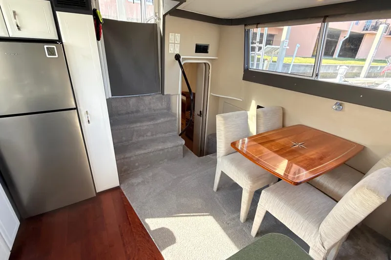 Slide: The Image of Interior of 1998 Mainship 47 Motor Yacht with dining area and modern kitchen. - 36