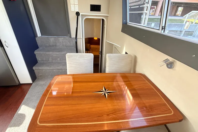 Slide: The Image of Interior of 1998 Mainship 47 Motor Yacht with elegant wooden table and seating. - 37