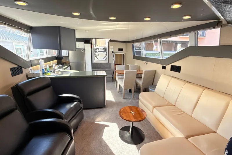 Slide: The Image of Luxurious interior of a 1998 Mainship 47 Motor Yacht with modern furnishings and ample seating. - 39