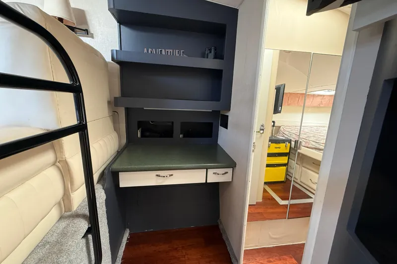 Slide: The Image of Interior of 1998 Mainship 47 Motor Yacht with bunk bed and desk area. - 55
