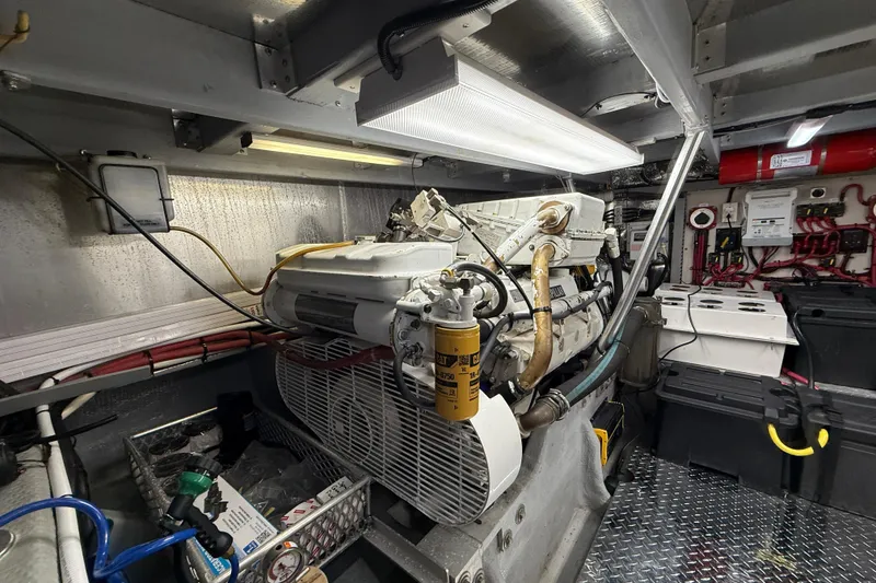 Slide: The Image of Engine room of 1998 Mainship 47 Motor Yacht with visible machinery and wiring. - 65
