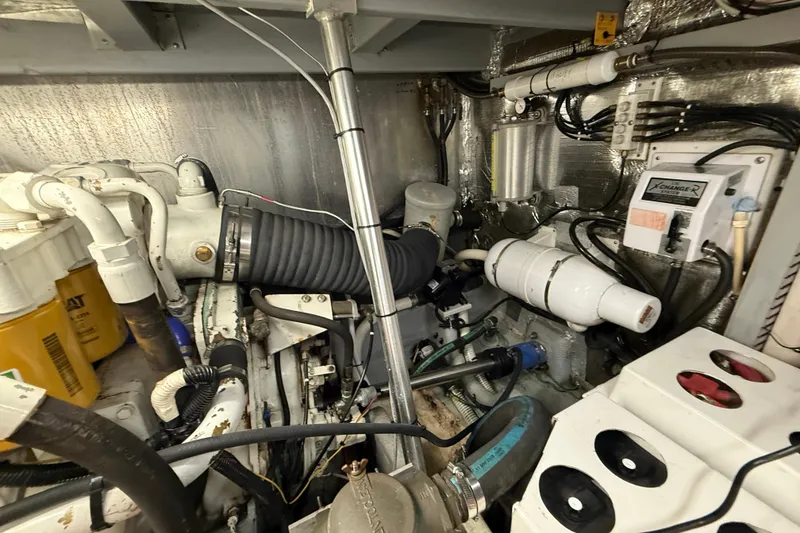 Slide: The Image of Engine room of 1998 Mainship 47 Motor Yacht with visible mechanical components. - 67
