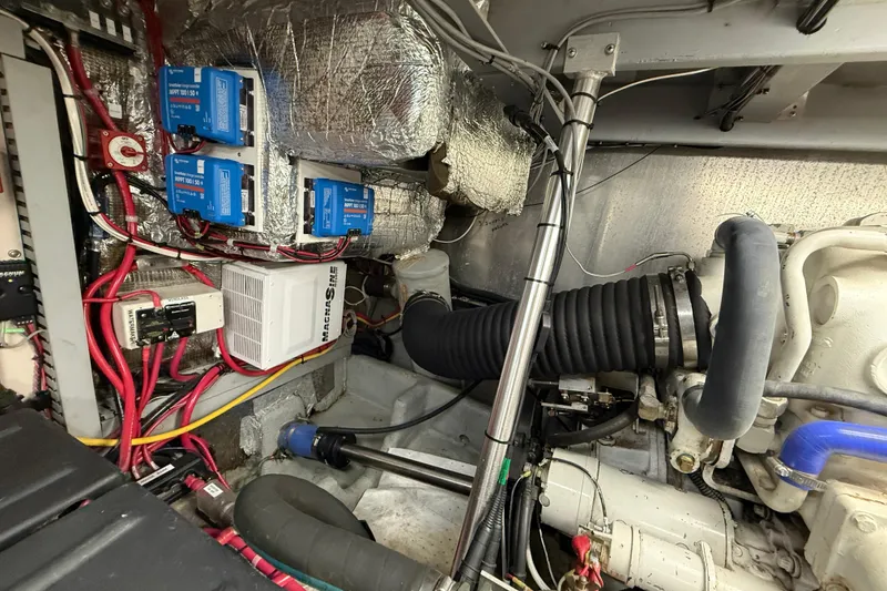 Slide: The Image of Engine room of a 1998 Mainship 47 Motor Yacht with wiring and components. - 68