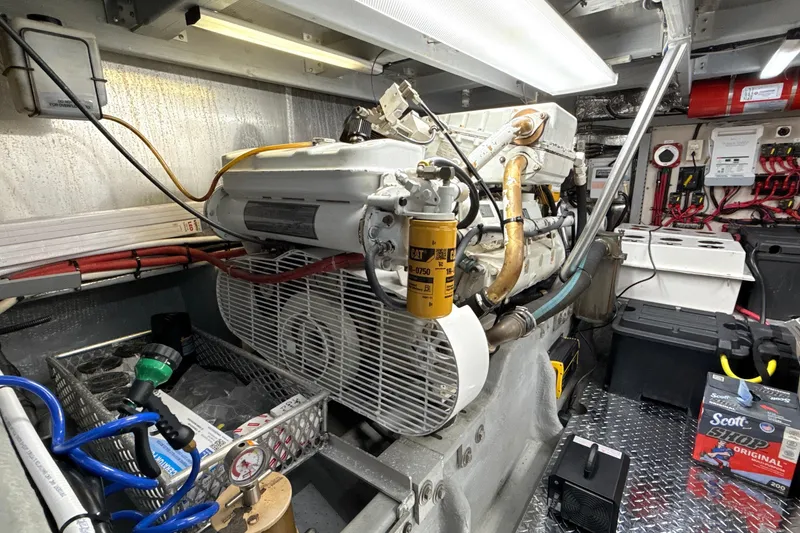 Slide: The Image of Engine room of a 1998 Mainship 47 Motor Yacht, showcasing mechanical components and equipment. - 75