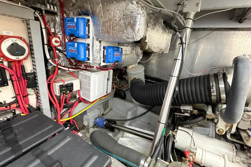 Slide: The Image of Engine room of a 1998 Mainship 47 Motor Yacht with wiring and components. - 78